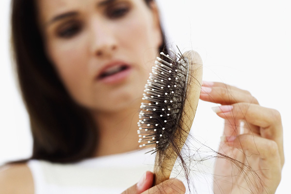 woman distraught at hair loss